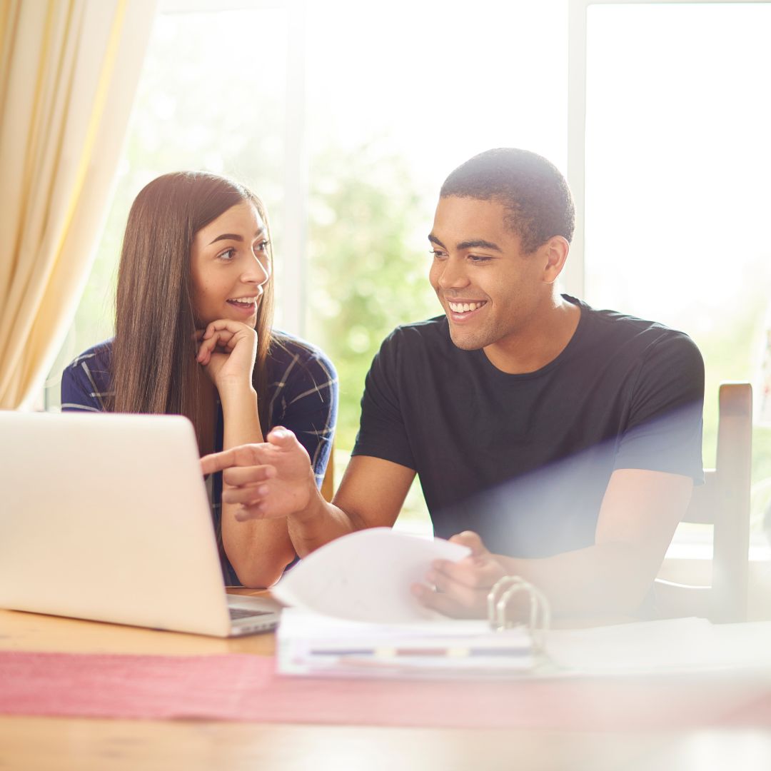 happy couple talking over computer