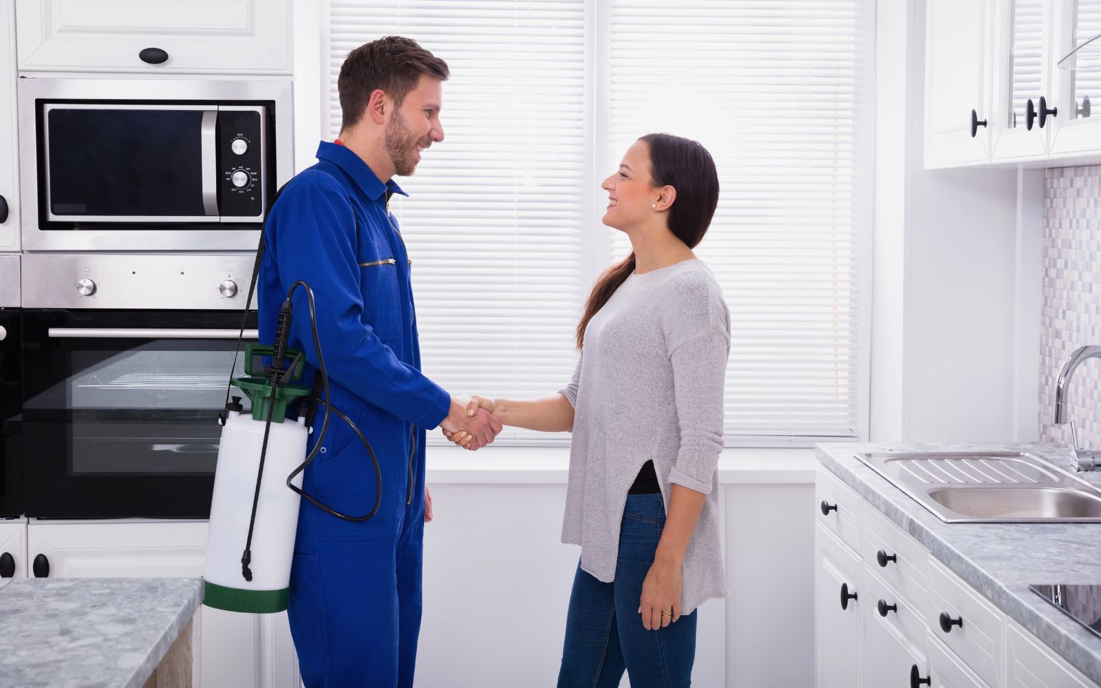 pest control expert and client shaking hands