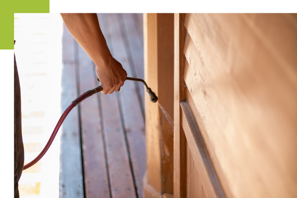a person spraying pest repellant